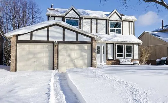 Residential driveway covered with snow before snow removal